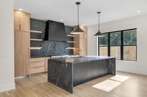 a kitchen with white cabinets and appliances