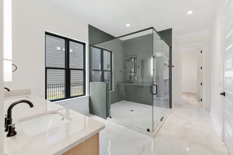 a bathroom with a shower and mirror