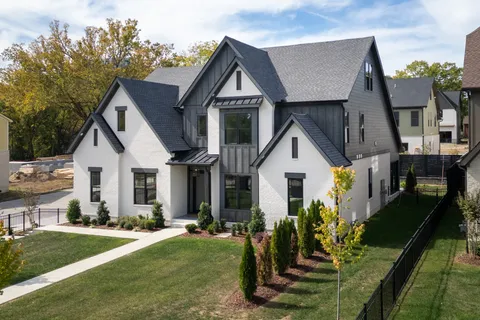 a front view of house with yard and green space