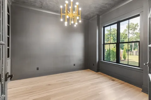 a view of an empty room with a fireplace and a window