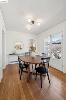 a dining room with furniture and wooden floor