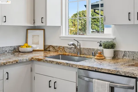 a kitchen with a stove top oven sink and cabinets