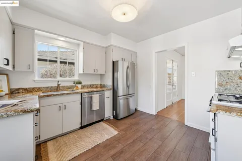 a kitchen with a sink stove and cabinets
