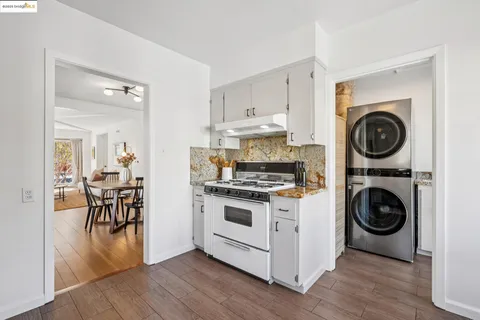 a view of a hallway with wooden floor windows and a livingroom
