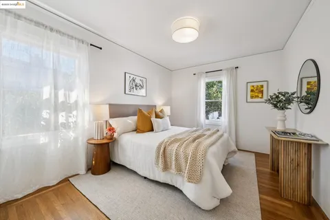a bathroom with a granite countertop toilet a sink and a window