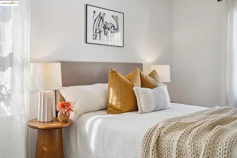 a bathroom with a granite countertop toilet sink and mirror