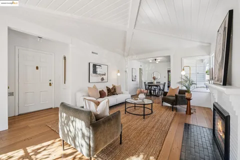 a living room with fireplace furniture and a wooden floor