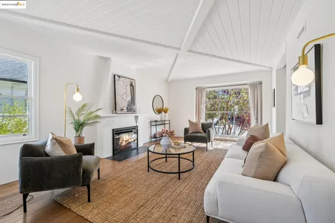 a living room with furniture fireplace and window