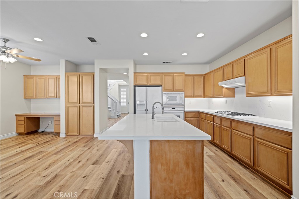 28355 Stansfield Lane Saugus, CA 91350 - Photo 16 of 52 a kitchen with stainless steel appliances granite countertop a sink stove and refrigerator