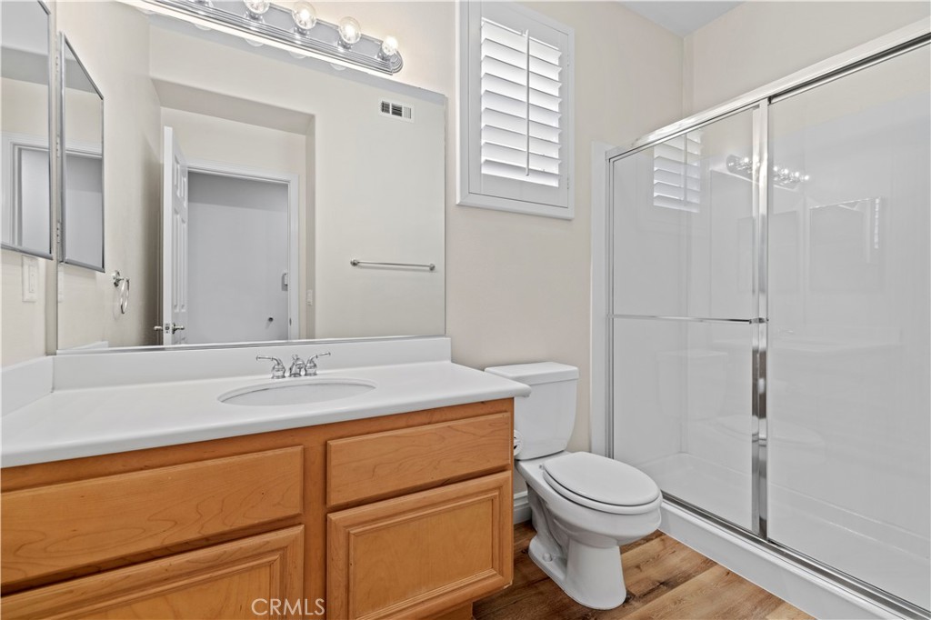 28355 Stansfield Lane Saugus, CA 91350 - Photo 24 of 52 a bathroom with a granite countertop sink toilet a mirror and shower