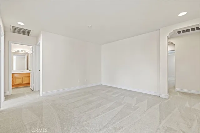 an empty room with a ceiling fan and a window