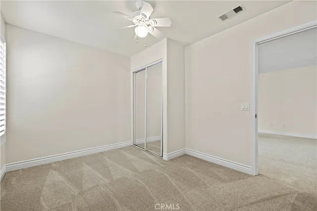 an empty room with windows and closet