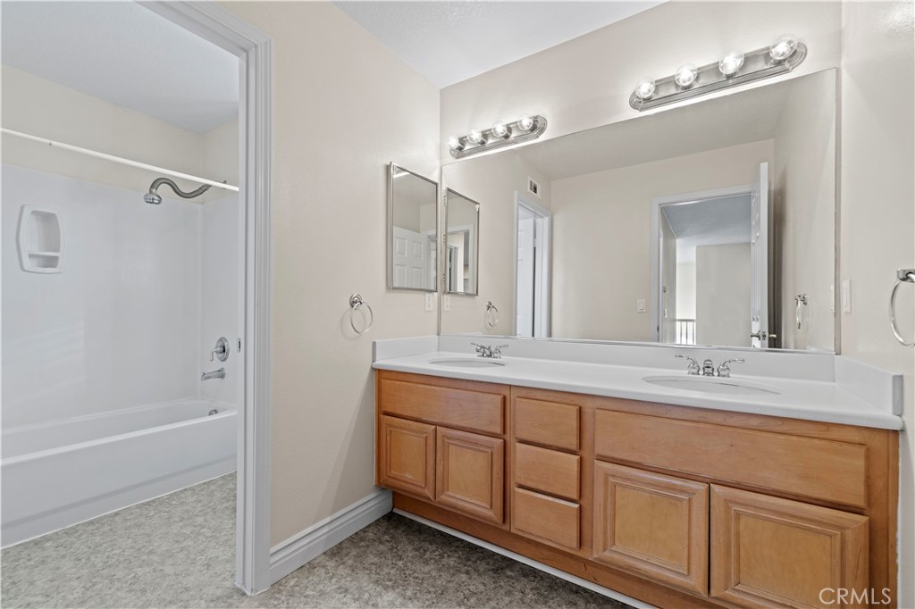28355 Stansfield Lane Saugus, CA 91350 - Photo 34 of 52 a spacious bathroom with a double vanity sink a mirror and a bathtub