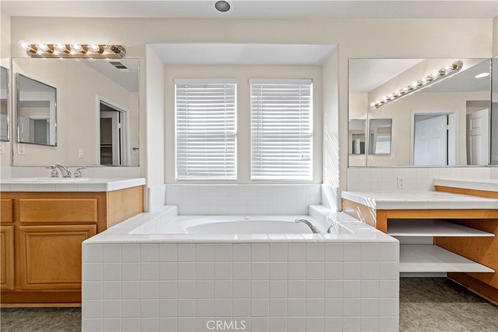 28355 Stansfield Lane Saugus, CA 91350 - Photo 43 of 52 a bathroom with a tub sink and mirror
