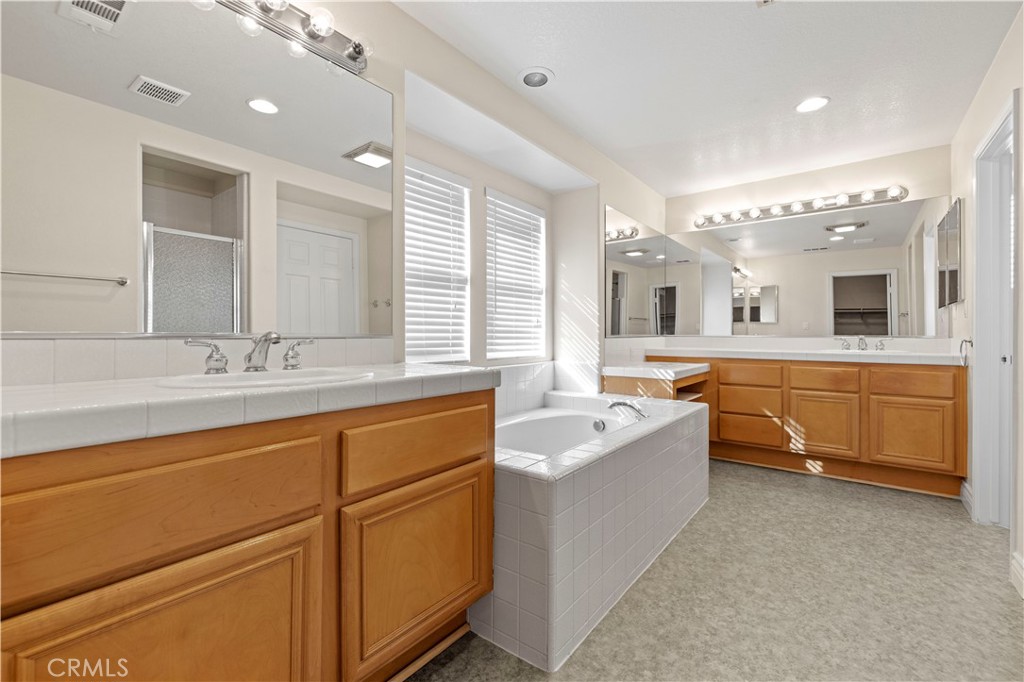 28355 Stansfield Lane Saugus, CA 91350 - Photo 45 of 52 a spacious bathroom with a double vanity sink mirror and bathtub