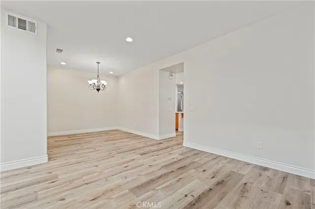 an empty room with wooden floor and sliding door