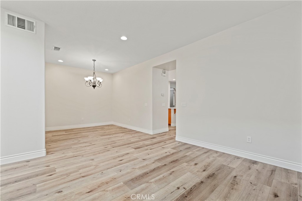 28355 Stansfield Lane Saugus, CA 91350 - Photo 8 of 52 an empty room with wooden floor and sliding door
