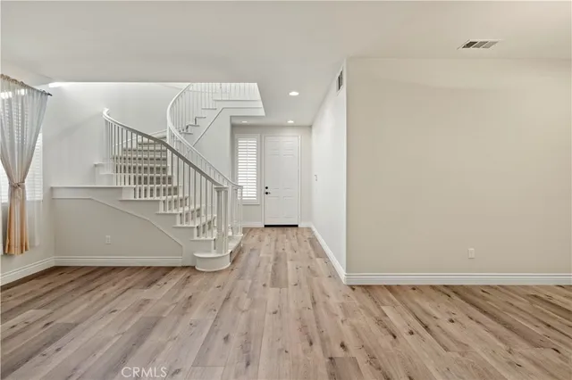 a view of entryway with wooden floor