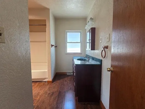 a view of walk in closet with empty racks