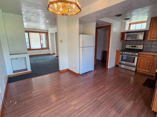 a kitchen with stainless steel appliances granite countertop a sink stove and cabinets