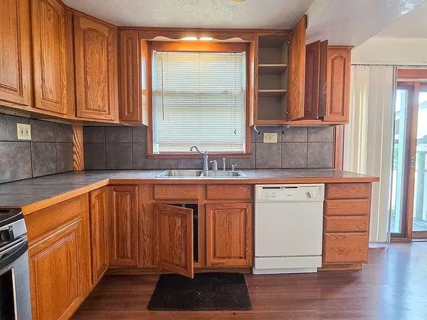 a stove top oven sitting inside of a kitchen