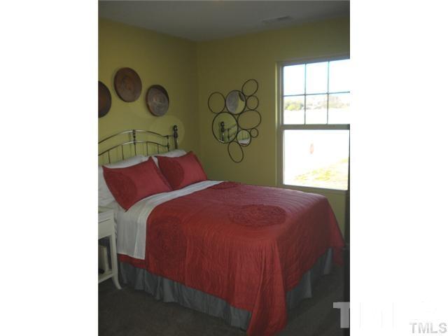 3518 Midway Island Court Raleigh, NC 27610 - Photo 4 of 10 a bedroom with a bed and a window