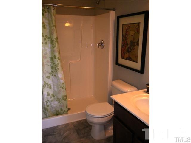 3518 Midway Island Court Raleigh, NC 27610 - Photo 6 of 10 a bathroom with a sink a toilet and shower