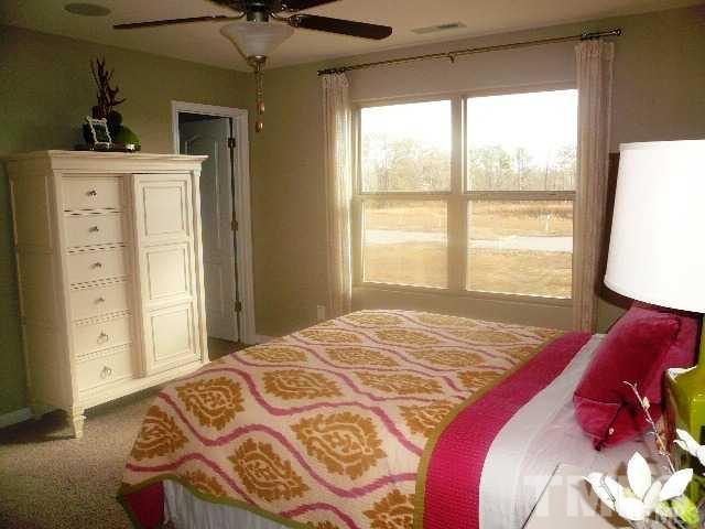 3518 Midway Island Court Raleigh, NC 27610 - Photo 7 of 10 a bedroom with a large bed and a window