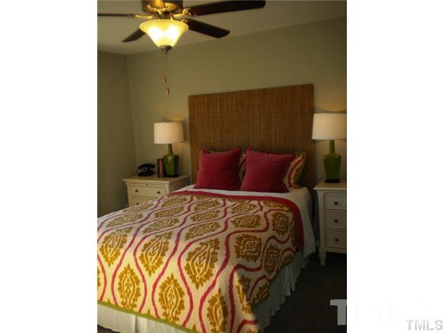 3518 Midway Island Court Raleigh, NC 27610 - Photo 8 of 10 a bedroom with a bed and a chandelier