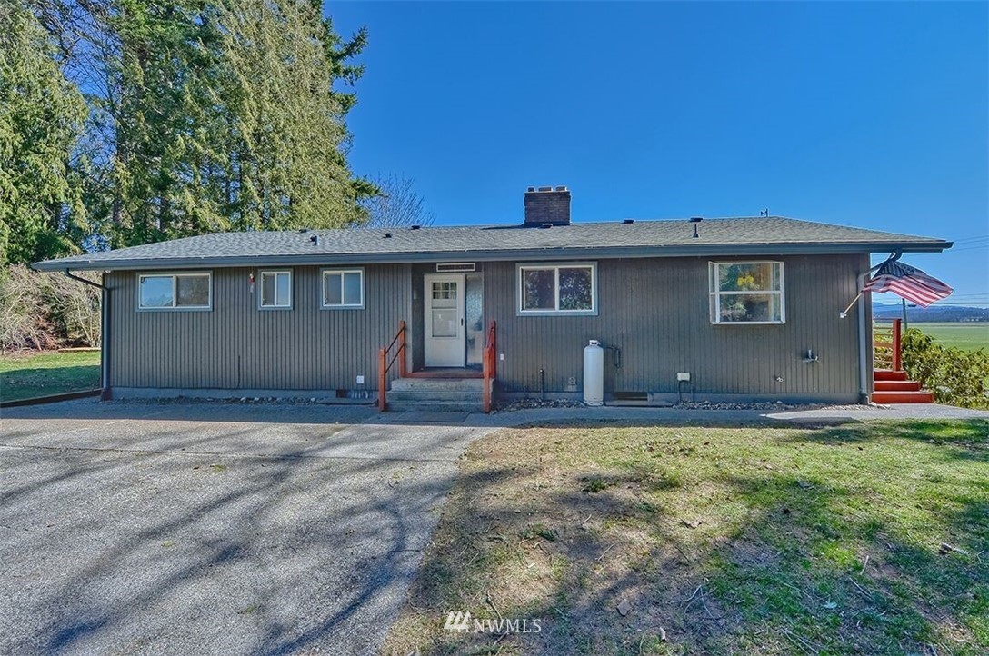 180 Beard Road Lynden, WA 98264 - Photo 1 of 27 a view of a house with backyard and a tree