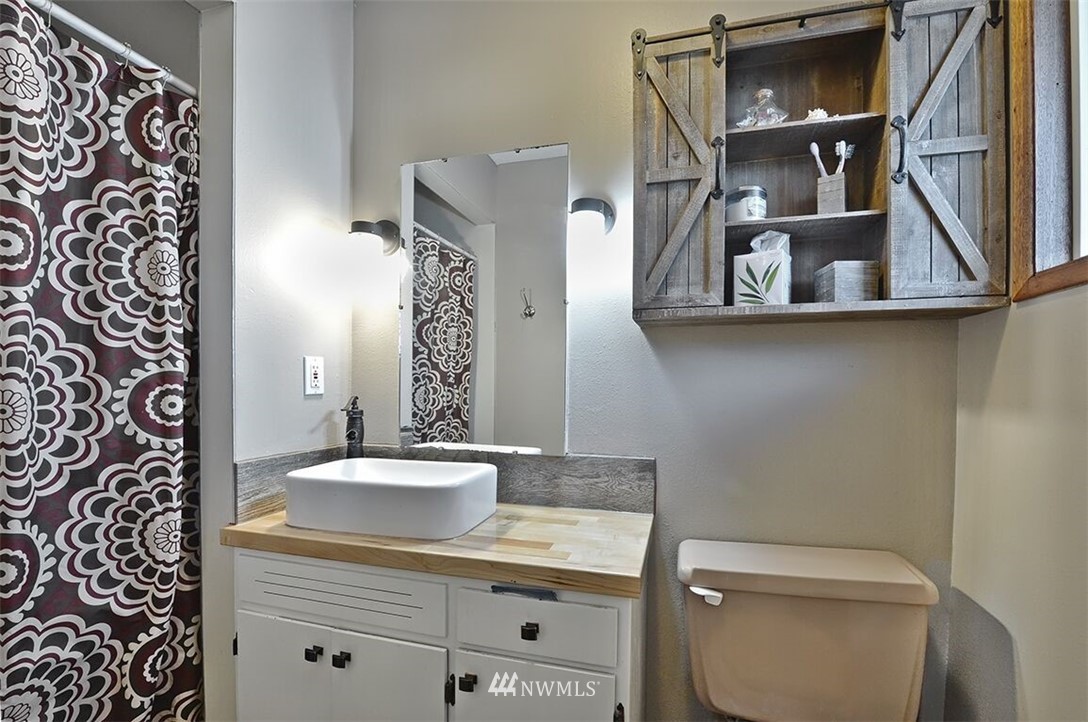 180 Beard Road Lynden, WA 98264 - Photo 11 of 27 a bathroom with a sink a toilet and mirror