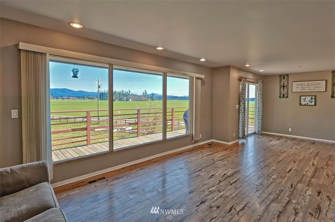 180 Beard Road Lynden, WA 98264 - Photo 13 of 27 a view of an empty room with wooden floor and a window