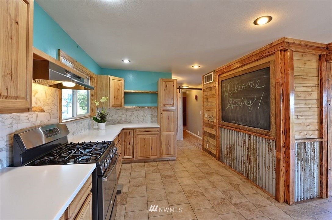 180 Beard Road Lynden, WA 98264 - Photo 14 of 27 a kitchen with stainless steel appliances granite countertop a stove a sink and a refrigerator