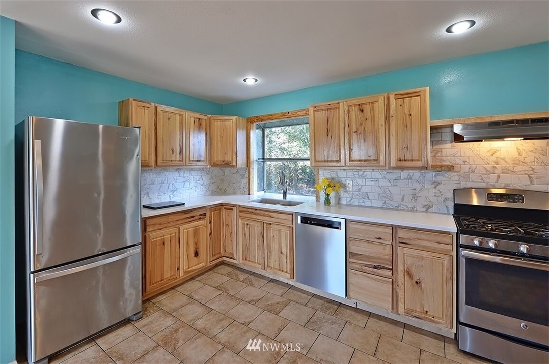 180 Beard Road Lynden, WA 98264 - Photo 15 of 27 a kitchen with stainless steel appliances granite countertop a refrigerator sink and stove