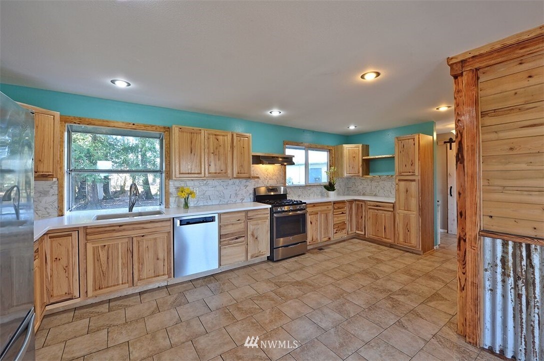 180 Beard Road Lynden, WA 98264 - Photo 16 of 27 a large kitchen with a large window and stainless steel appliances