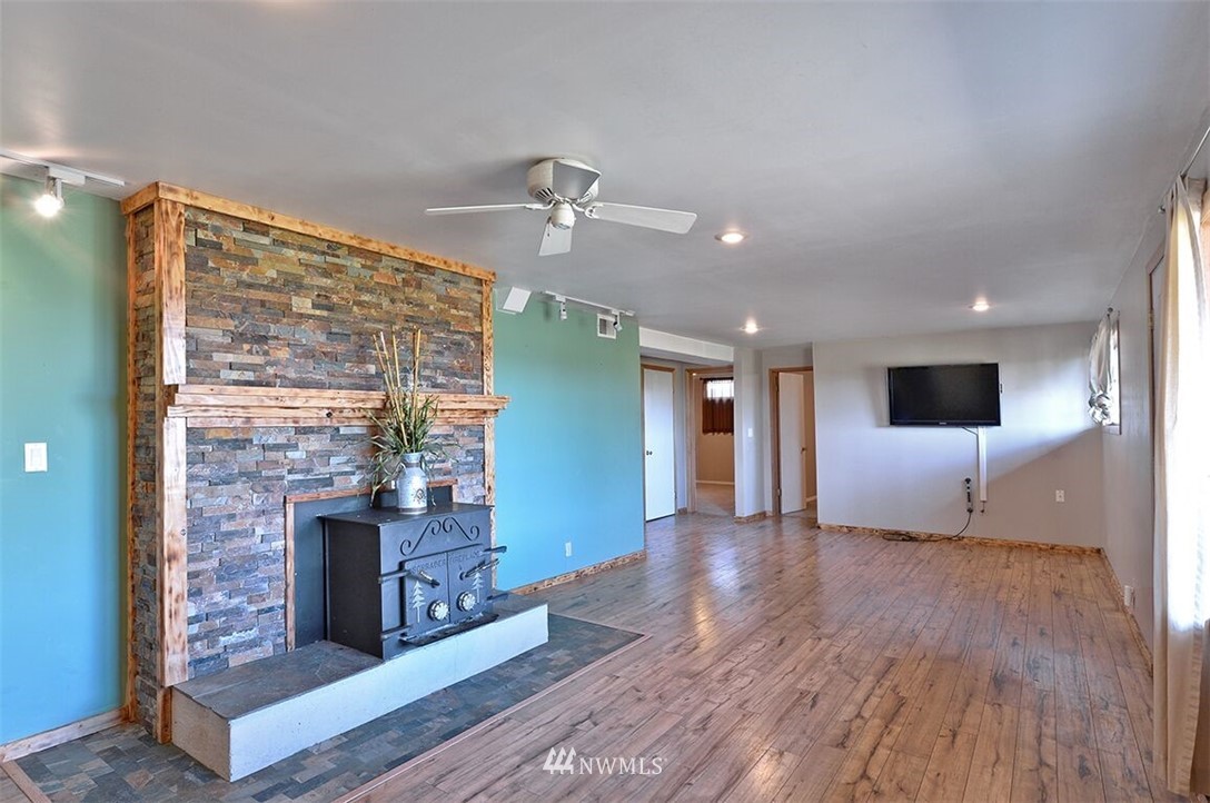 180 Beard Road Lynden, WA 98264 - Photo 20 of 27 a view of an empty room with wooden floor and a fireplace