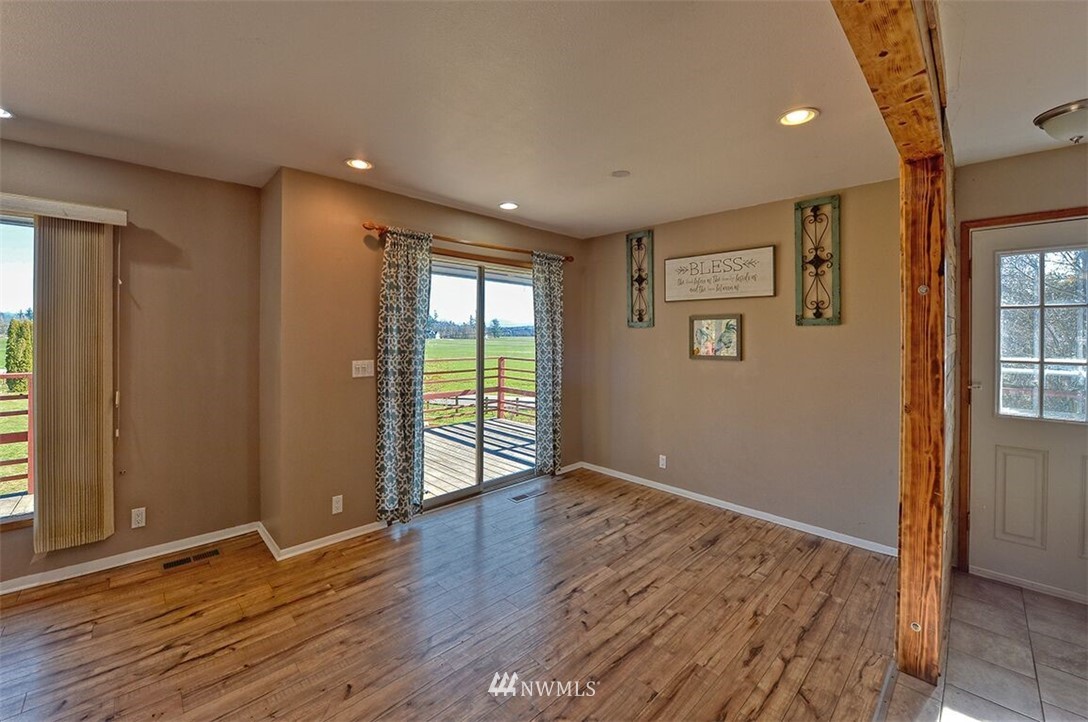 180 Beard Road Lynden, WA 98264 - Photo 23 of 27 an empty room with wooden floor and windows