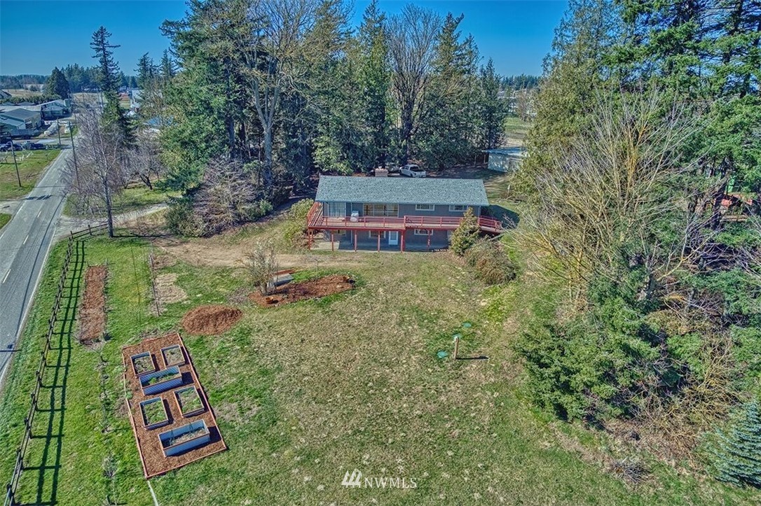 180 Beard Road Lynden, WA 98264 - Photo 9 of 27 a backyard of a house with large trees and plants