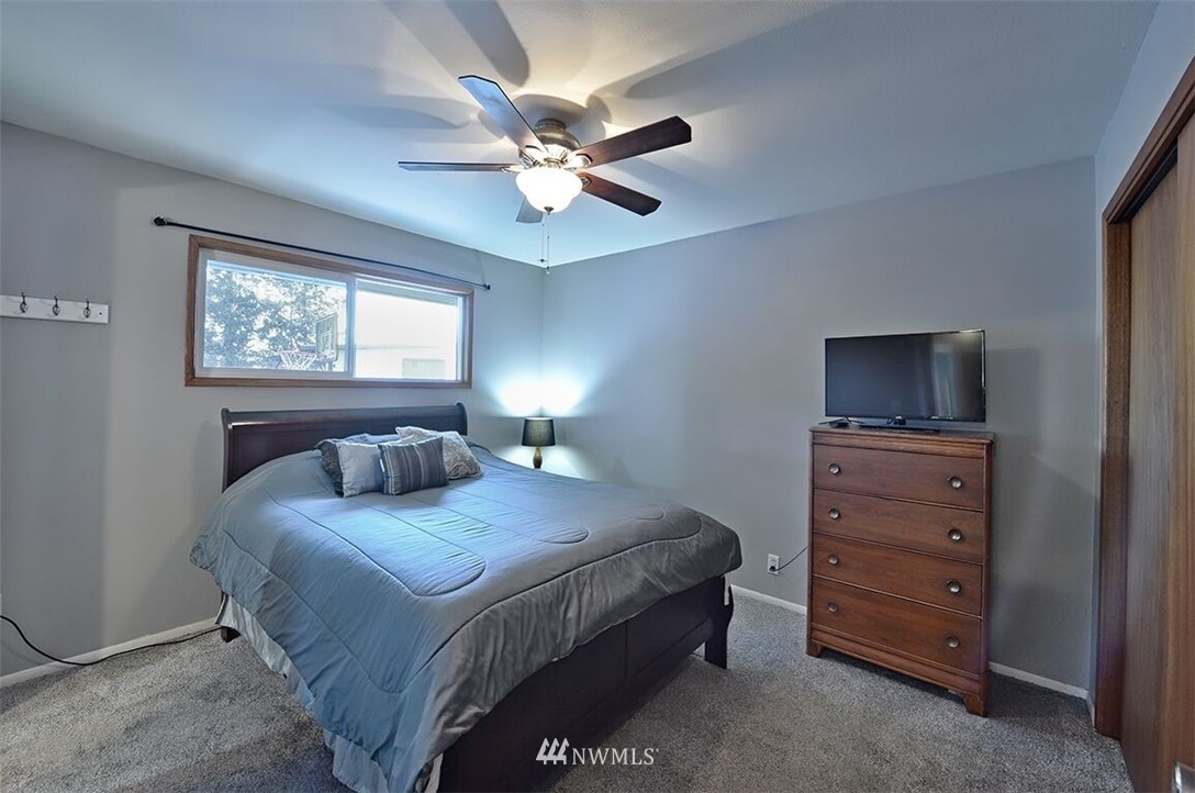 180 Beard Road Lynden, WA 98264 - Photo 10 of 27 a bedroom with a bed and a chandelier