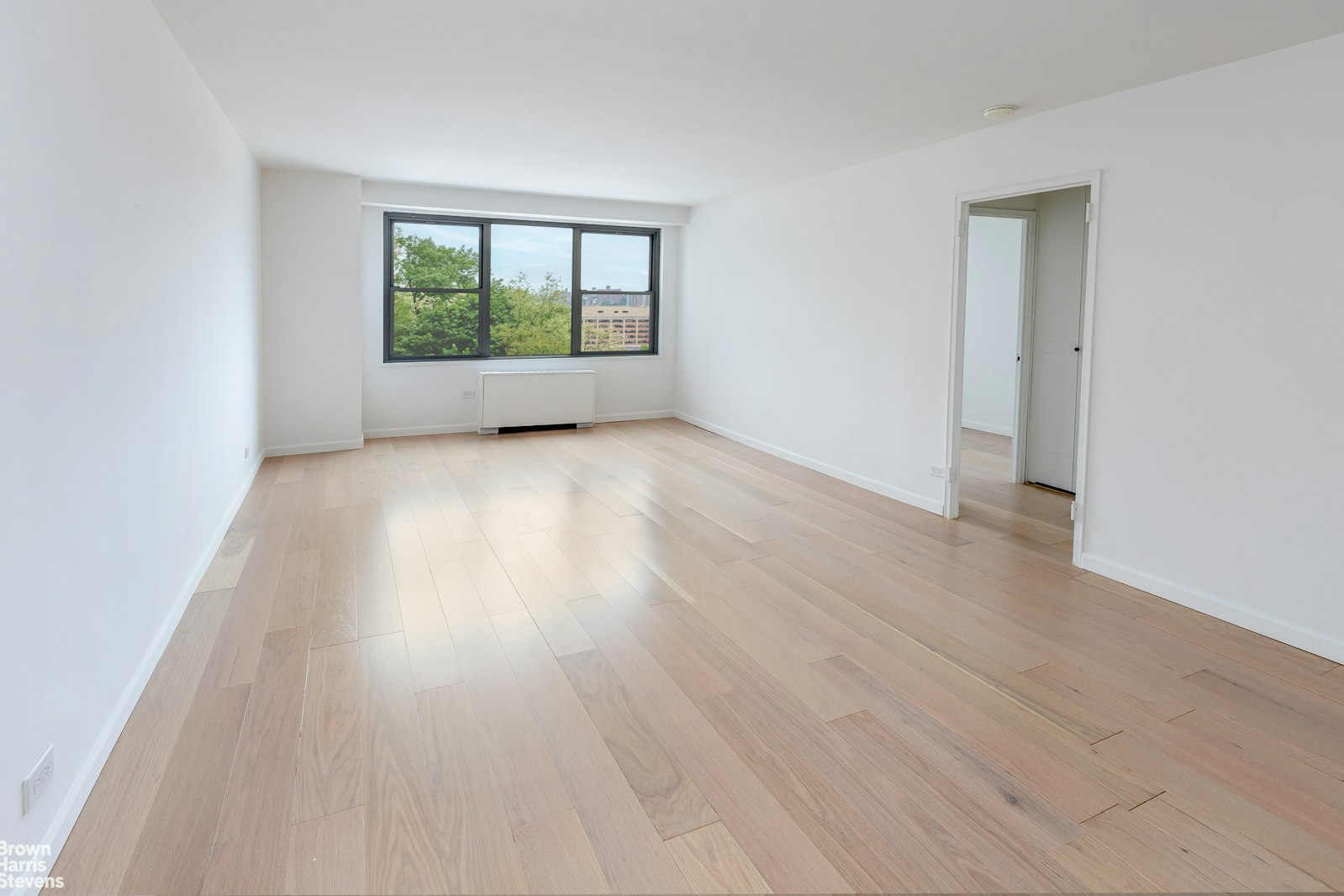 2500 Johnson Avenue, Unit 3B Bronx, NY 10463 - Photo 24 of 42 an empty room with wooden floor and windows