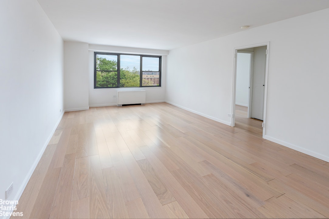 2500 Johnson Avenue, Unit 3B Bronx, NY 10463 - Photo 3 of 42 an empty room with wooden floor and windows
