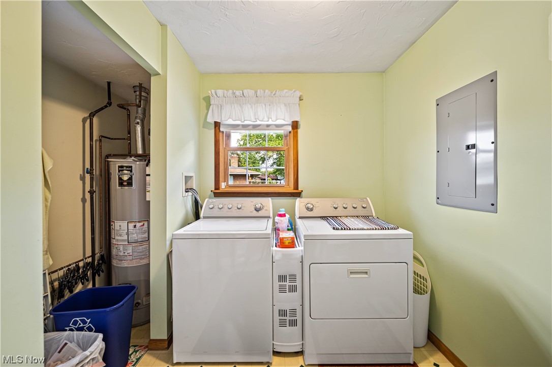 431 Ansel Road Geneva, OH 44041 - Photo 22 of 35 Clothes washing area with washer and dryer, gas water heater, and light tile flooring