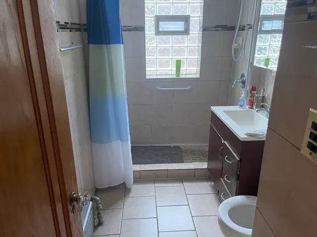 a bathroom with a sink toilet and shower