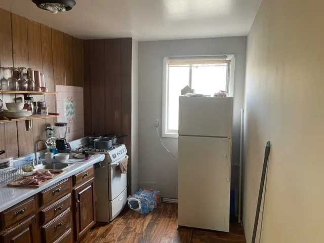 a kitchen with a refrigerator and a stove