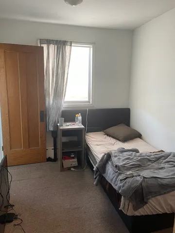 a bedroom with a bed and a window