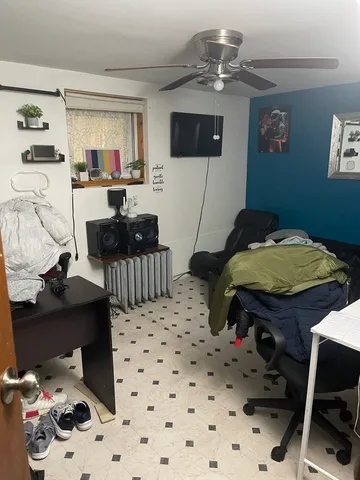 a bedroom with a bed and a tv on the dresser