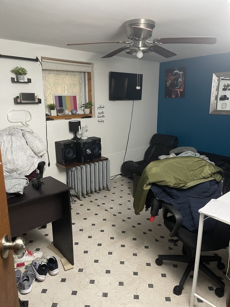 5631 West Cornelia Avenue Chicago, IL 60634 - Photo 23 of 28 a bedroom with a bed and a tv on the dresser