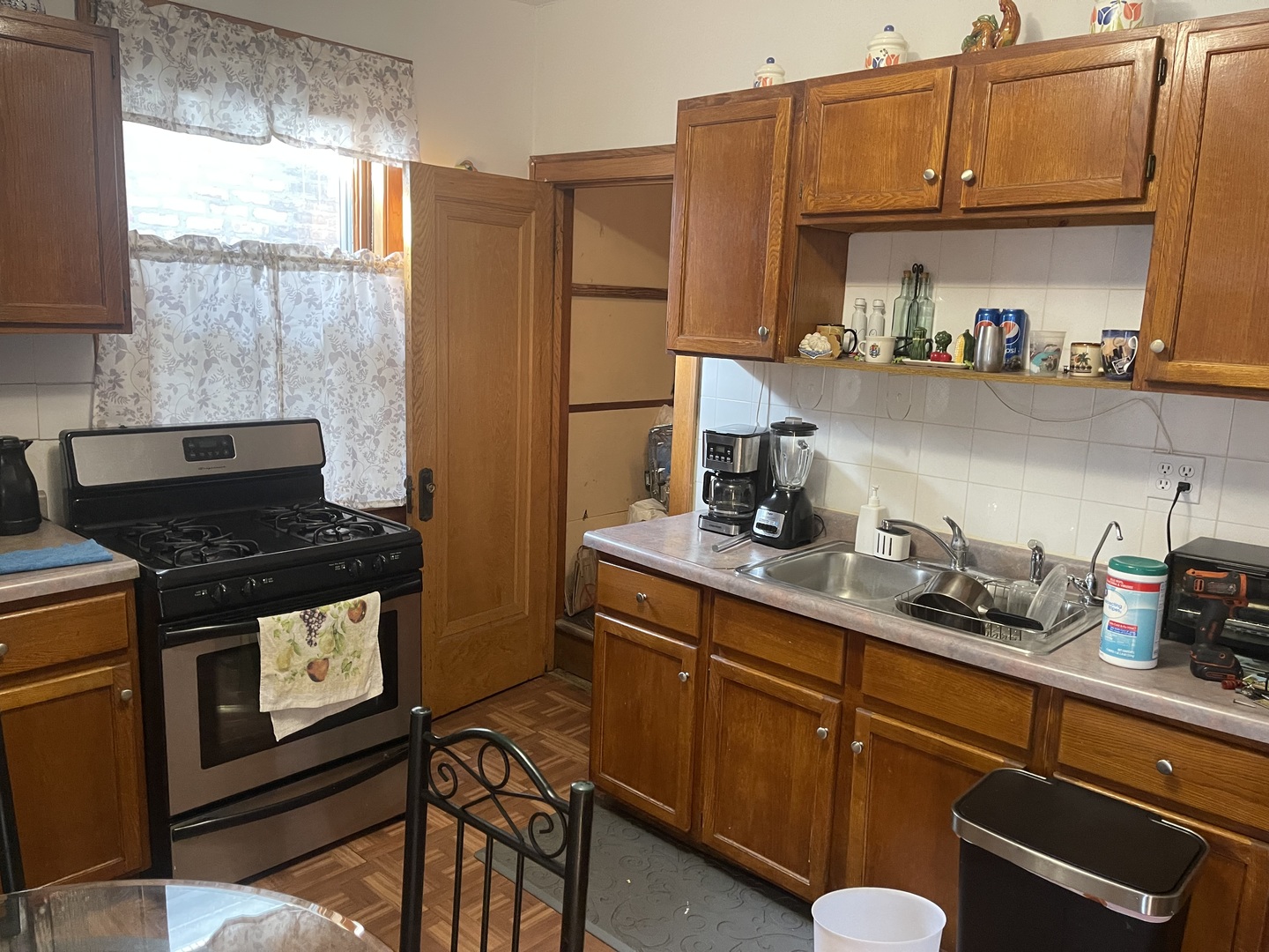 5631 West Cornelia Avenue Chicago, IL 60634 - Photo 6 of 28 a kitchen with stainless steel appliances granite countertop a stove a sink and a refrigerator