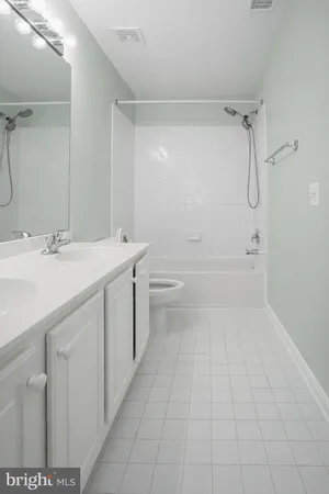 a bathroom with a sink a toilet and a shower