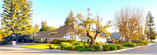 a view of a house with swimming pool and a yard